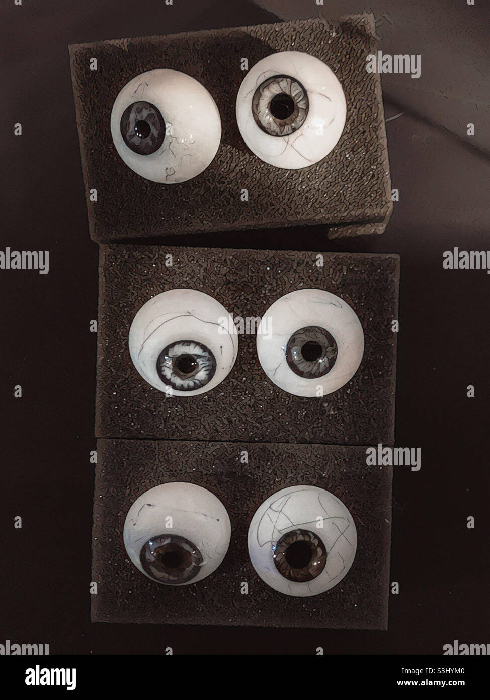 Glass eyes.  False eyes.  Eye of wisdom.  Eye of the beholder. AI - Smartphone Captured Stock Image