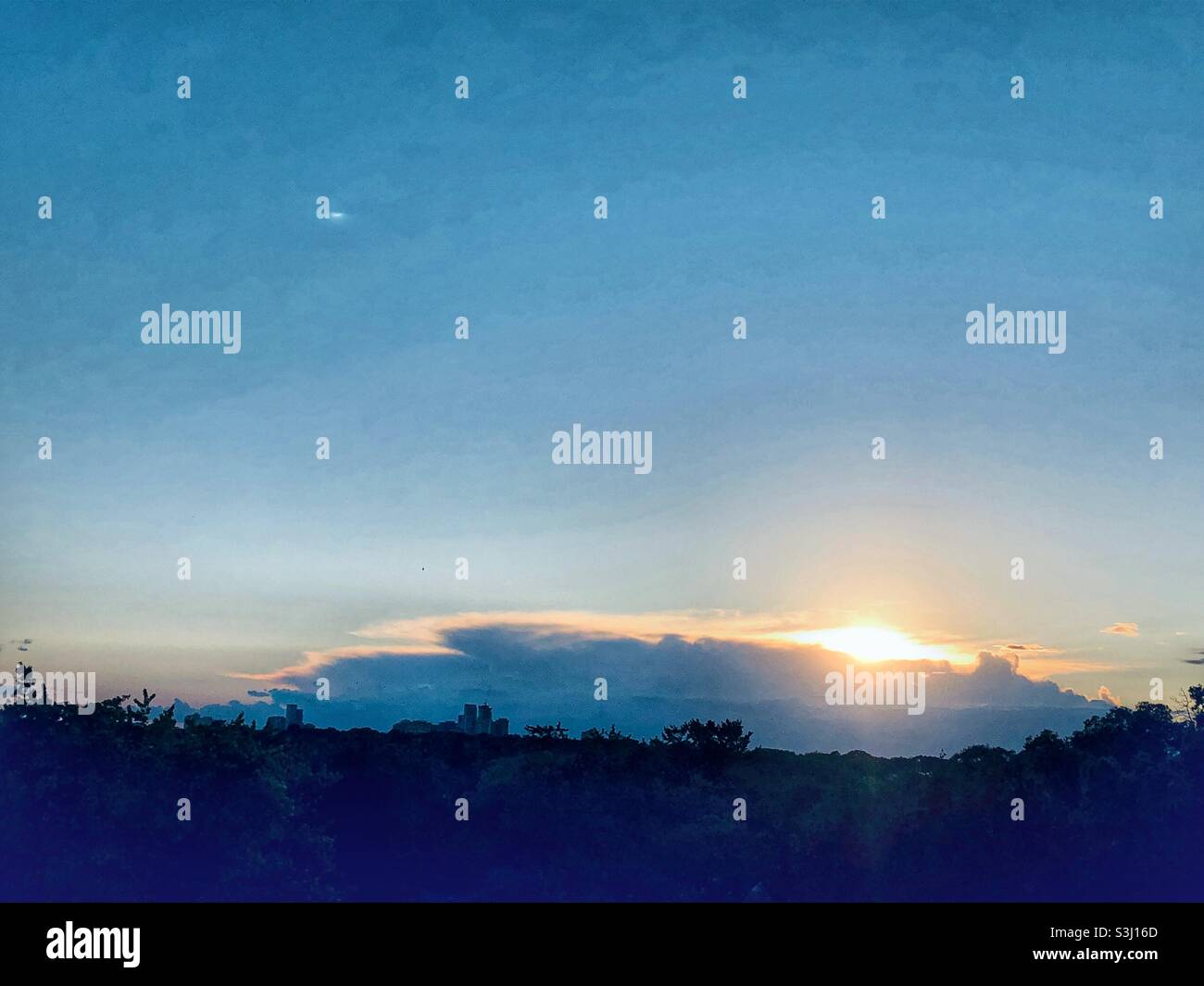 A sunset on the horizon on a clear evening. Stock Photo