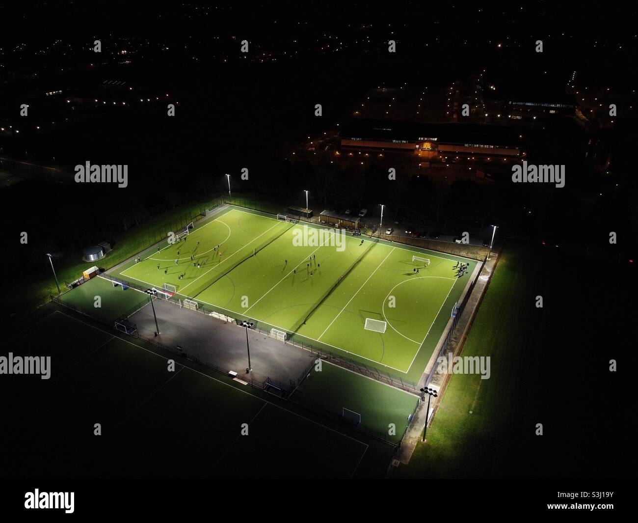 Floodlit local football pitch during training night Stock Photo