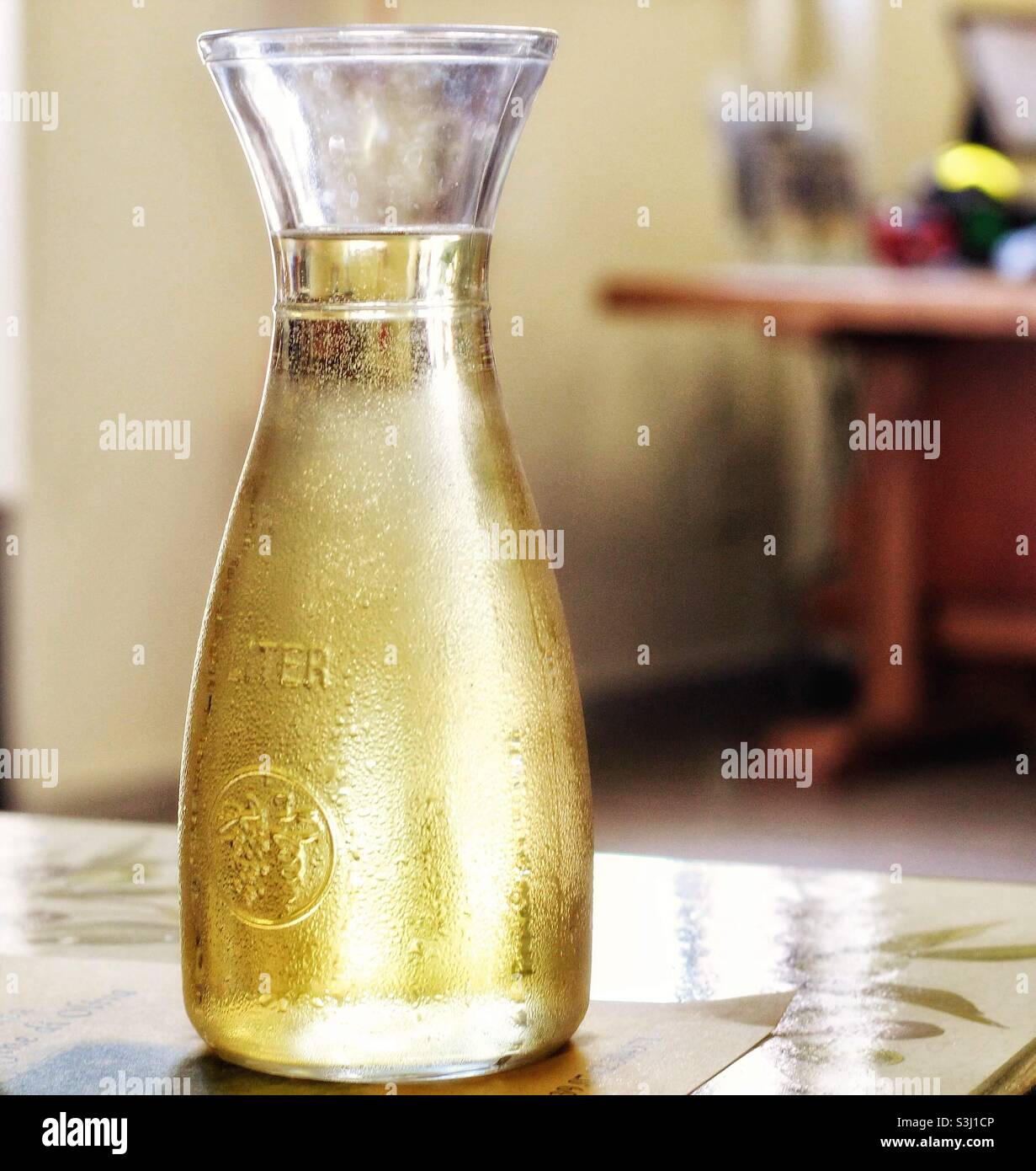 Carafe of Italian white wine on a table Stock Photo