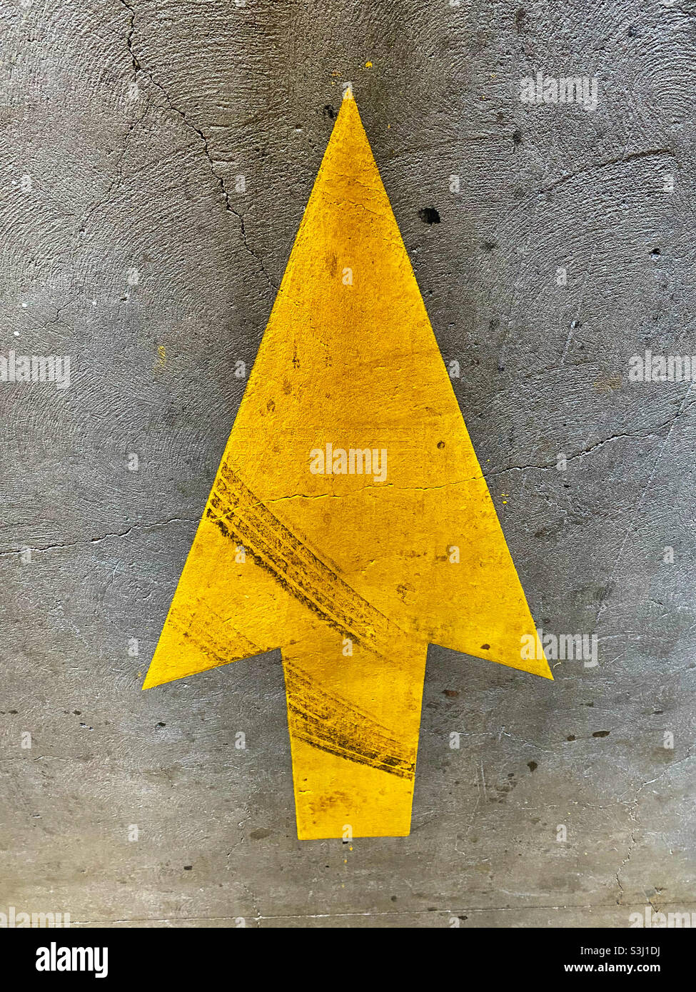 Yellow traffic arrow wit tire marks Stock Photo Alamy