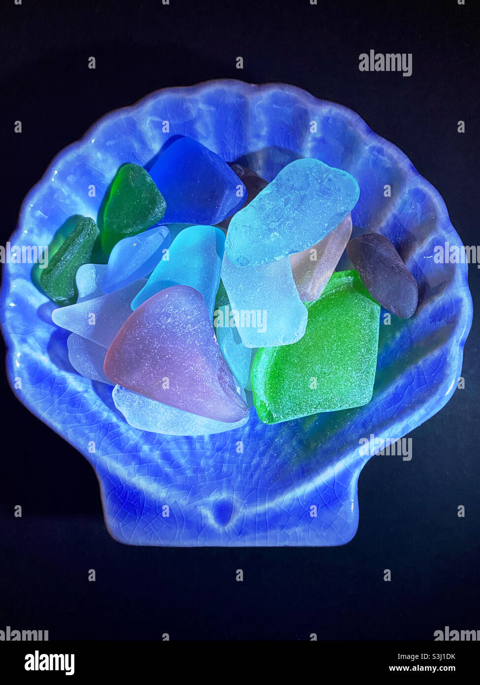 Smooth beach glass in a shell-shaped dish - Smartphone Captured Stock Image