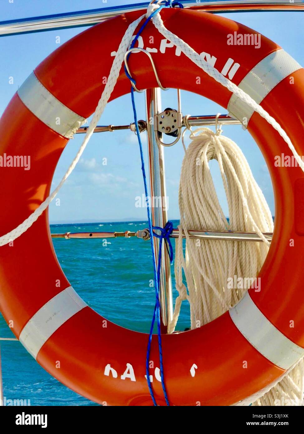 Red lifesaver on boat looking over the ocean Stock Photo