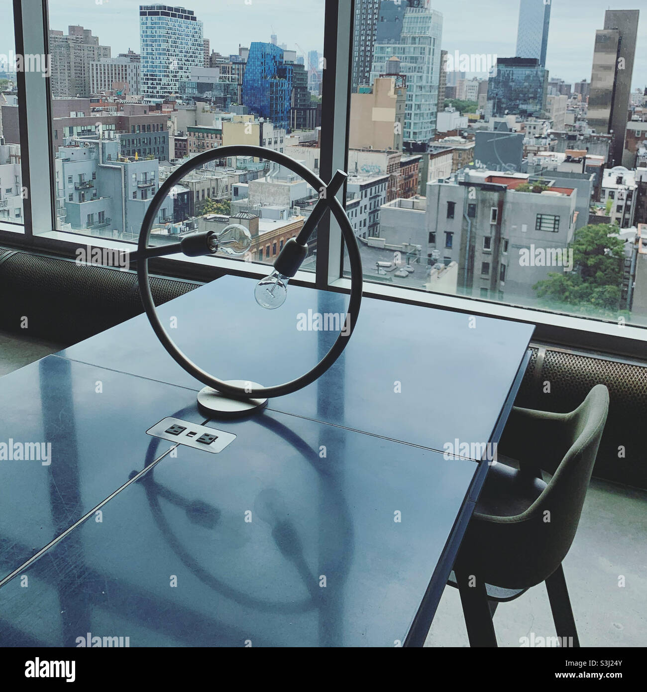 Table and lighting in a public area with a view, Hotel Indigo, Lower East Side, Manhattan, New York, New York, United States - Smartphone Captured Stock Image