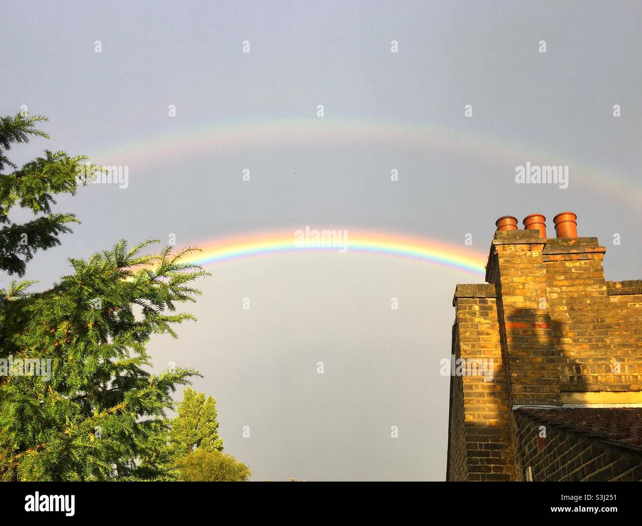 A double rainbow over the chimney pots of Kondon - Smartphone Captured Stock Image