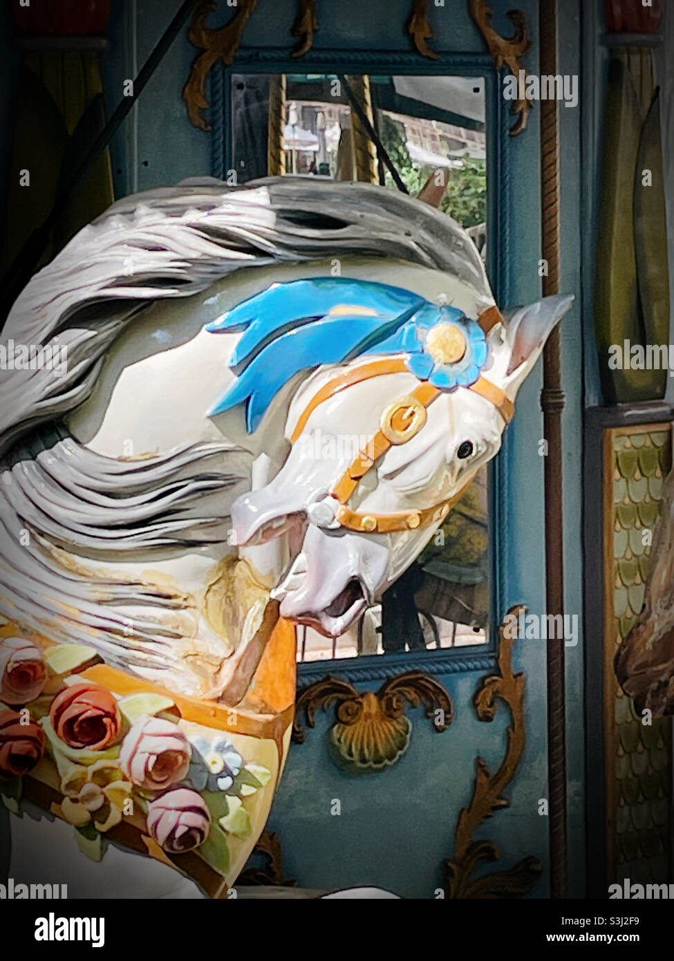 A carved wooden horse figure on the Merry go round in Bryant Park, 2021 - Smartphone Captured Stock Image