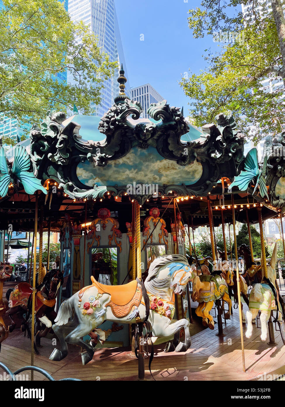 The merry-go-round ride in Bryant Park features elegantly carved horses and a kitty 2021, New York City, USA - Smartphone Captured Stock Image
