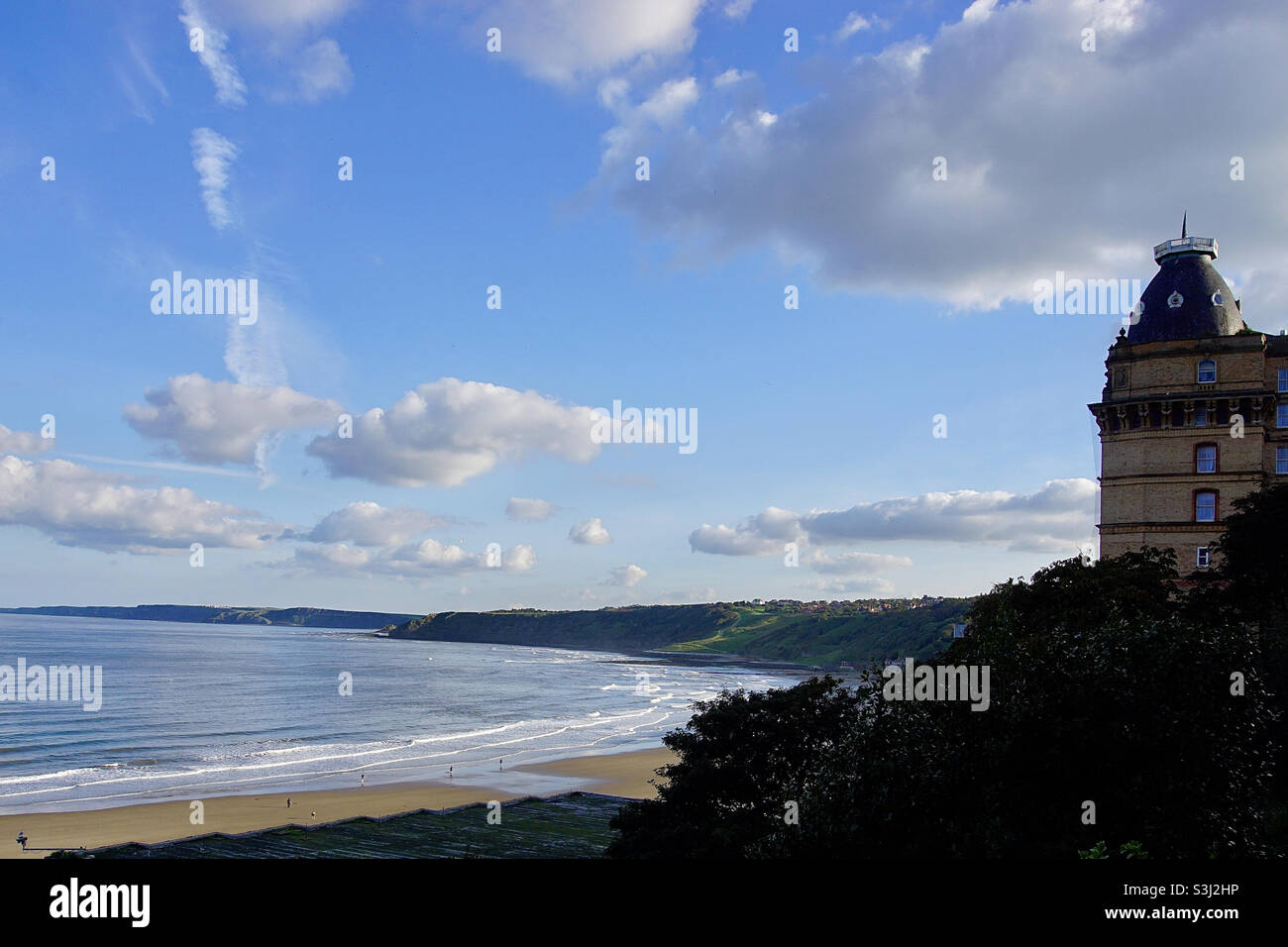 Evening view of Scarborough South Bay sands looking towards Filey and showing part of the Grand Hotel.Scarborough is a popular UK seaside resort developed in Victorian times by use of the railway. Stock Photo