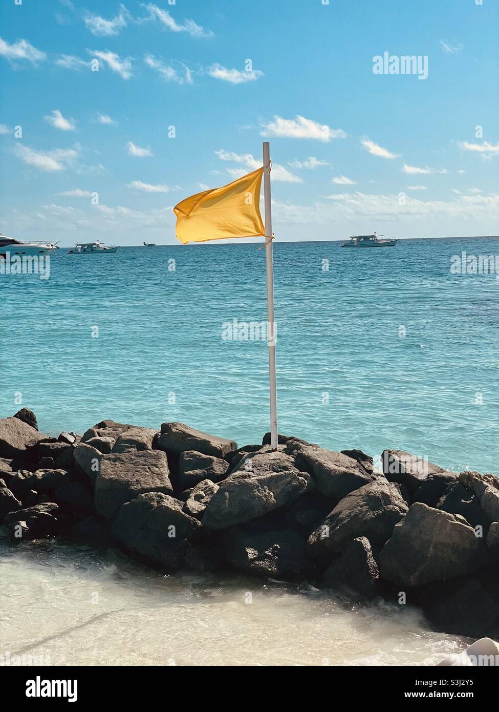 Yellow Swimming Flag on Beach Rocks, Maldives Stock Photo Alamy