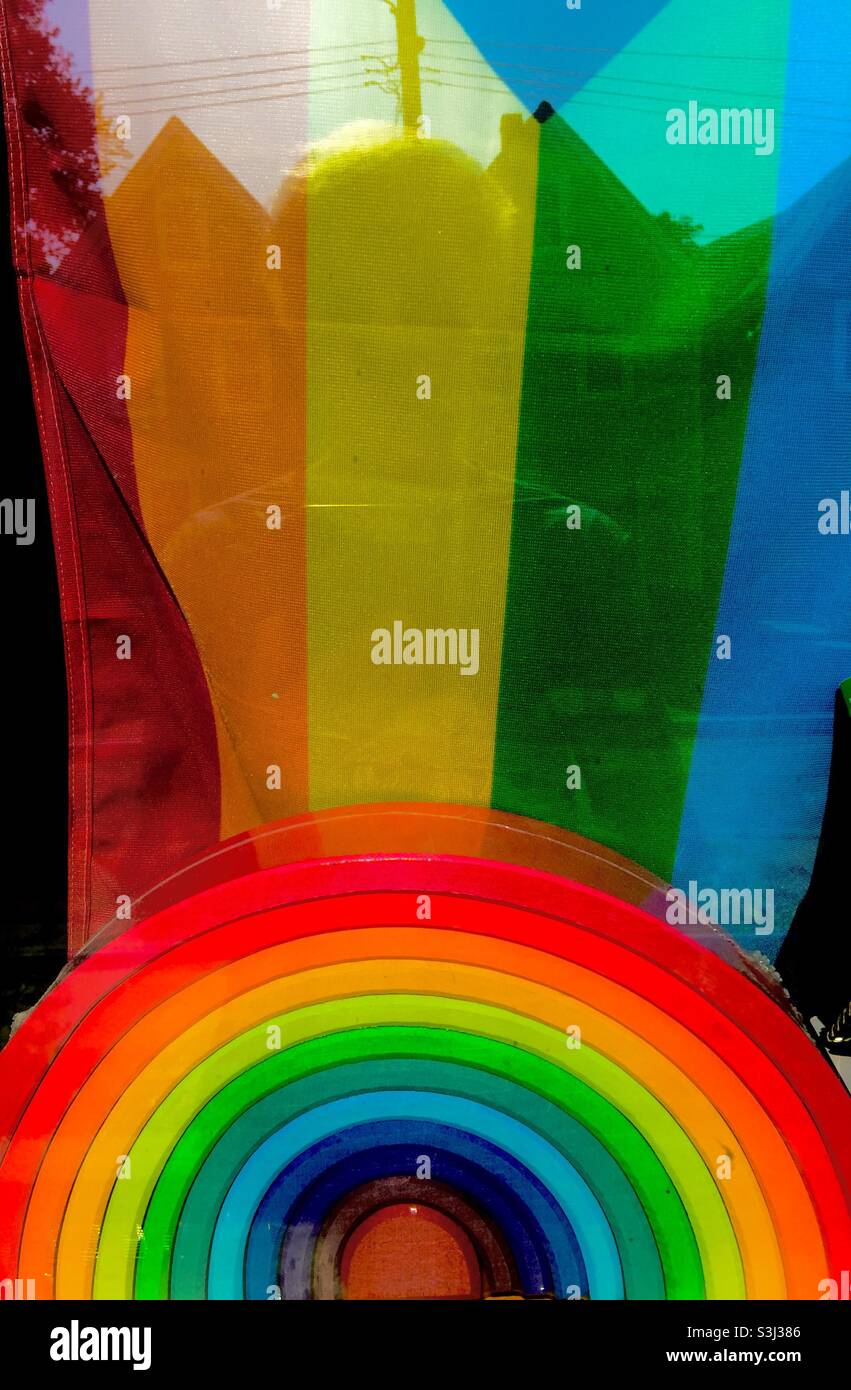 All inclusive: A toy rainbow in vibrant colours and an LGBTQ2+flag in a store window, Halifax, Canada. Display. Showcase. - Smartphone Captured Stock Image