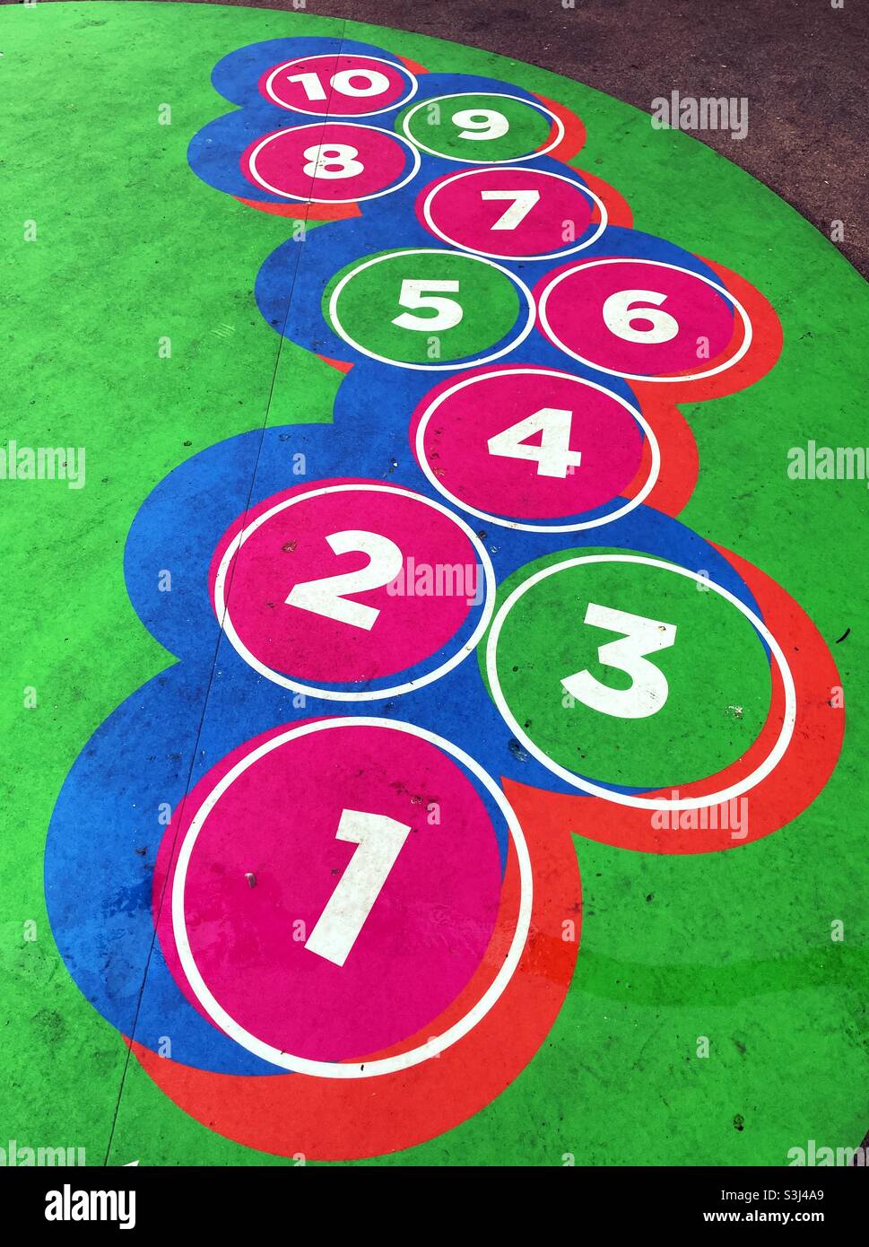 Colorful stylized hopscotch game on an outdoor patio, USA - Smartphone Captured Stock Image