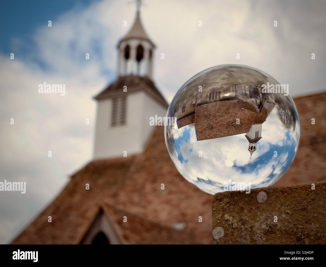 St Simon and St Jude church, Quendon, Essex UK through a glass balls - Smartphone Captured Stock Image