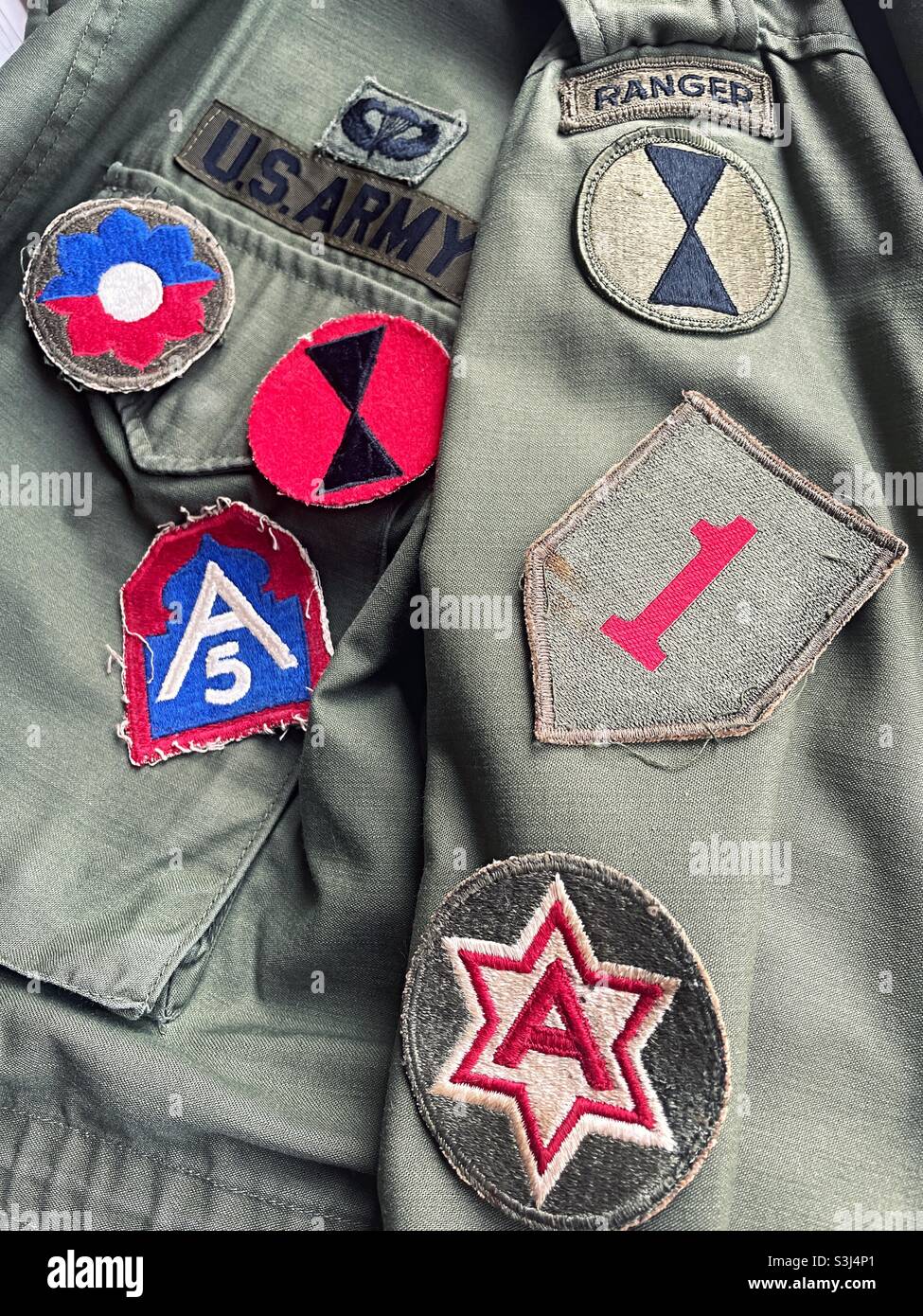 Close up of vintage unit patches on a 1970s officers field jacket, USA - Smartphone Captured Stock Image