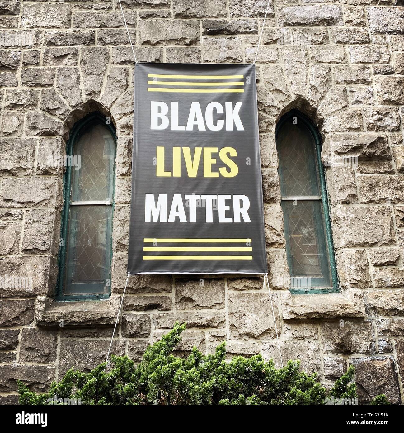 Black Lives Matter banner on the side of a church - Smartphone Captured Stock Image