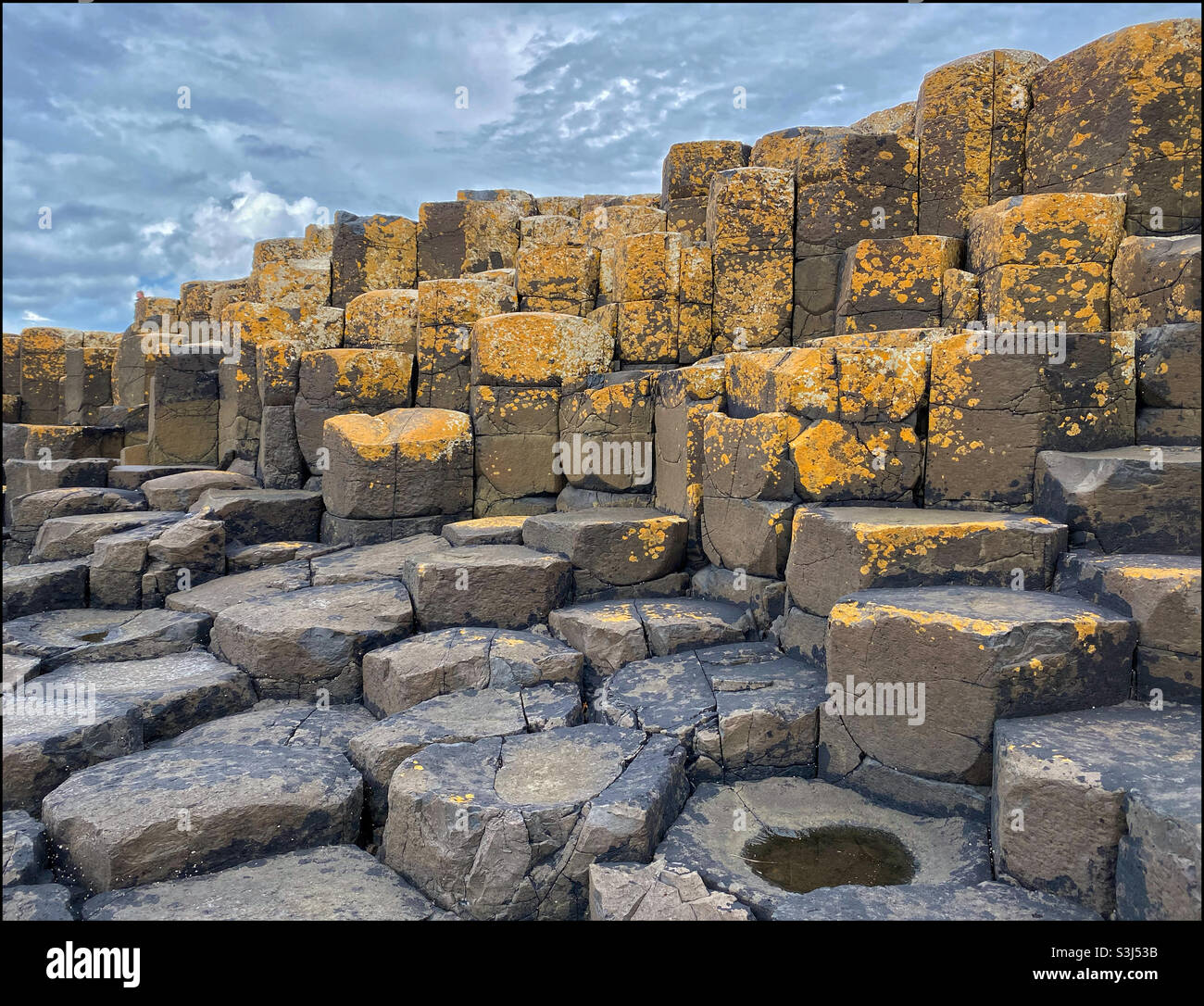 A view of the hexagonal basalt columns that make up the rock formations at Giant’s Causeway in Co. Antrim, Northern Ireland. This geology formed 60 million years as a result of volcanic eruptions. ©️ - Smartphone Captured Stock Image