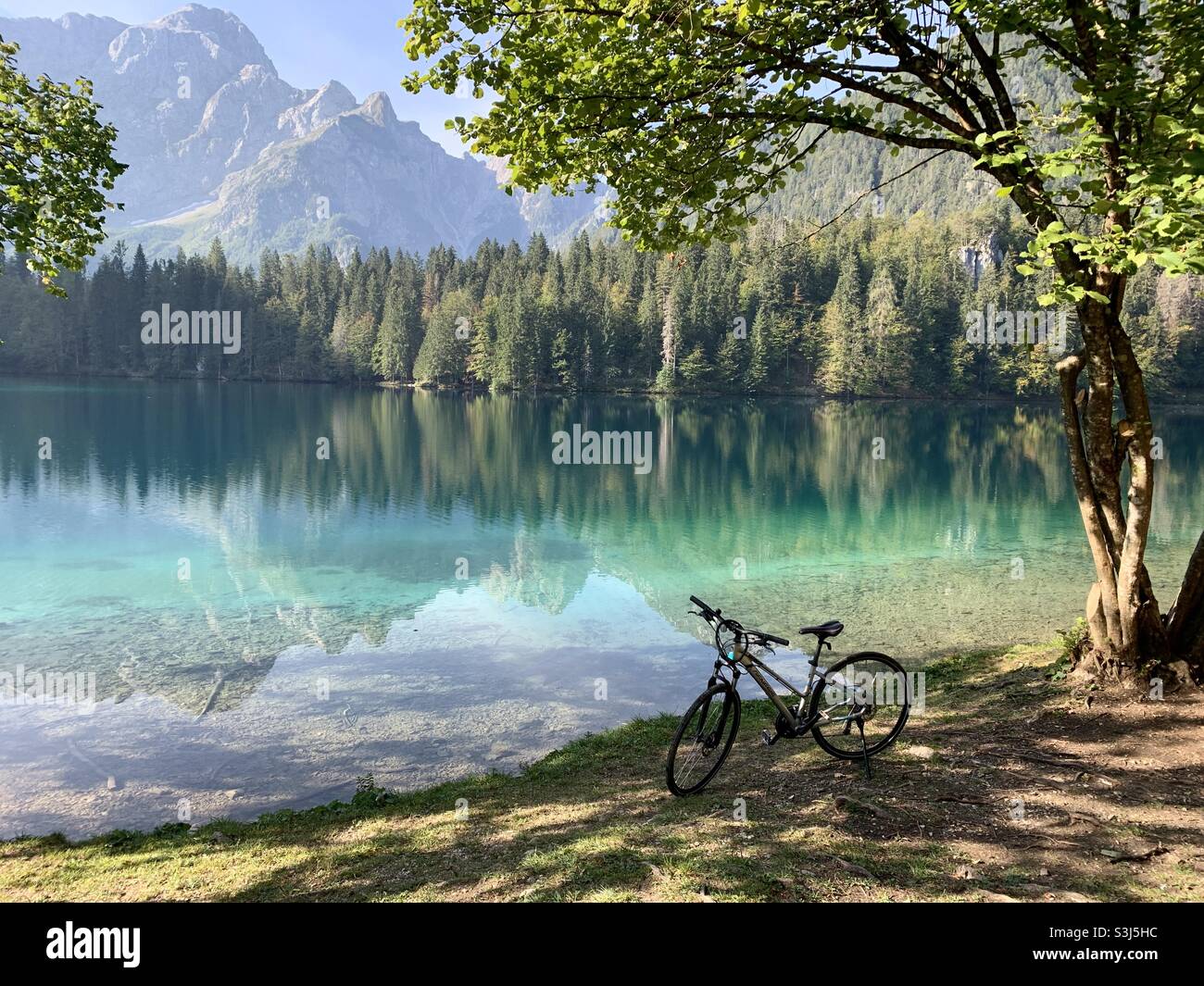 Bike next to lake fuzine Italy Stock Photo