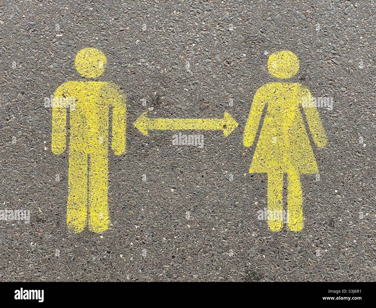 Social distancing sign on the floor at a train station Stock Photo