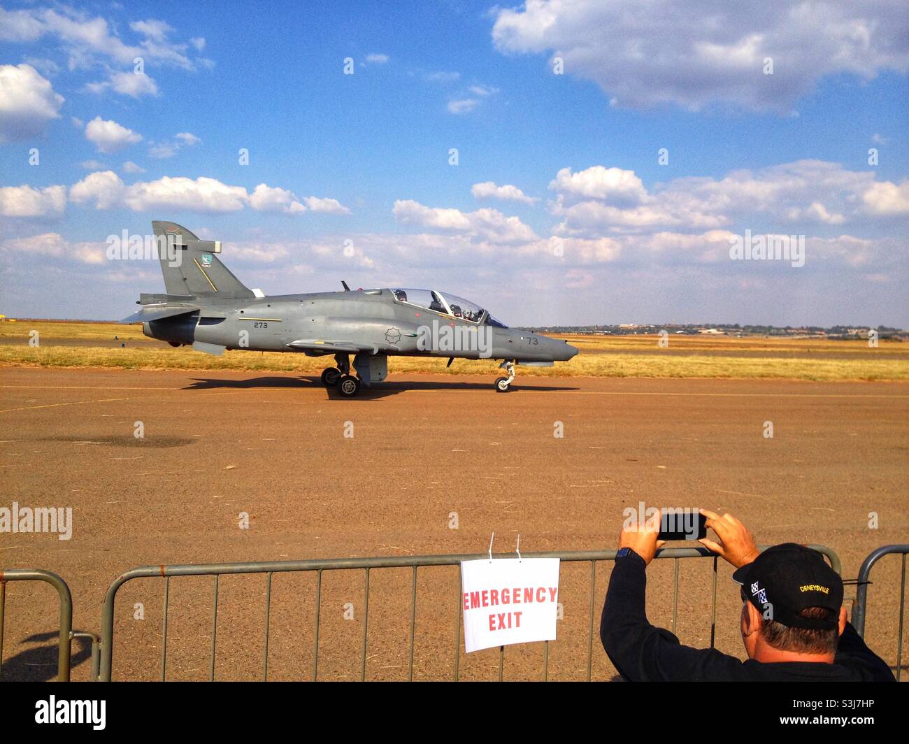 A spectator taking a photo of a fighter jet at an air show in South Africa Stock Photo