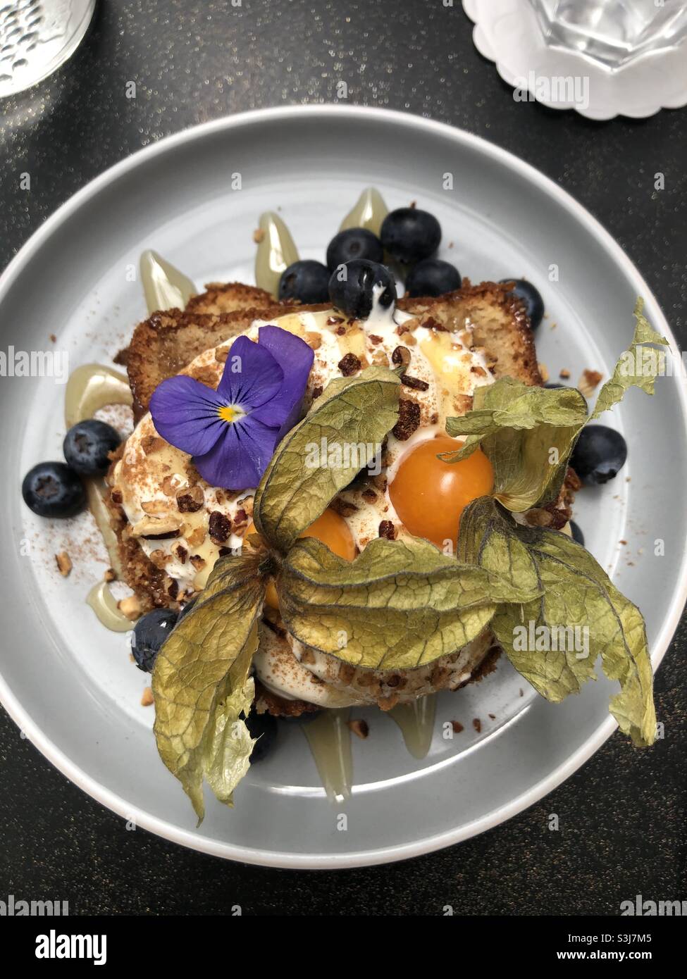 A beautiful breakfast of banana bread, yoghurt, honey and berries with