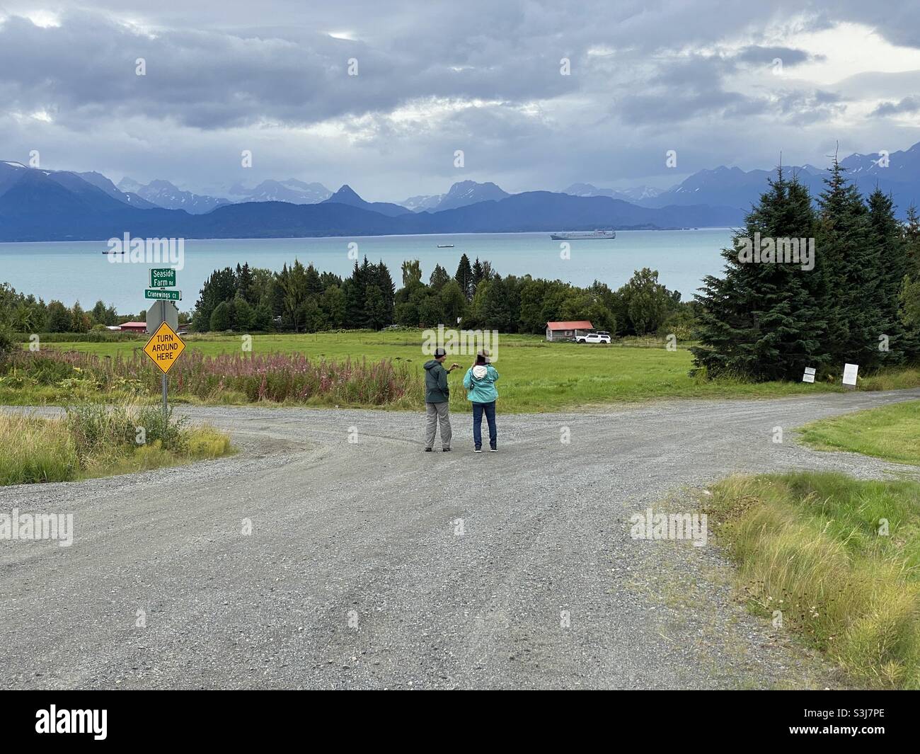 Women stand at a crossroads overlooking Cook Inlet and Katchemak bay near Homer Alaska. Stock Photo