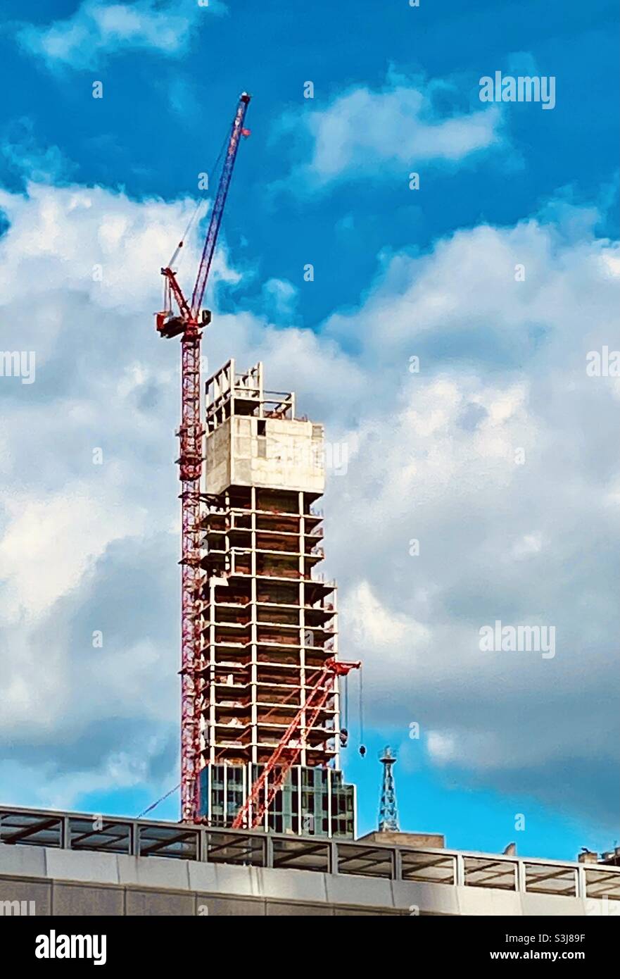 Skyscraper under construction with a crane in the financial district, 2021, NYC, United States - Smartphone Captured Stock Image