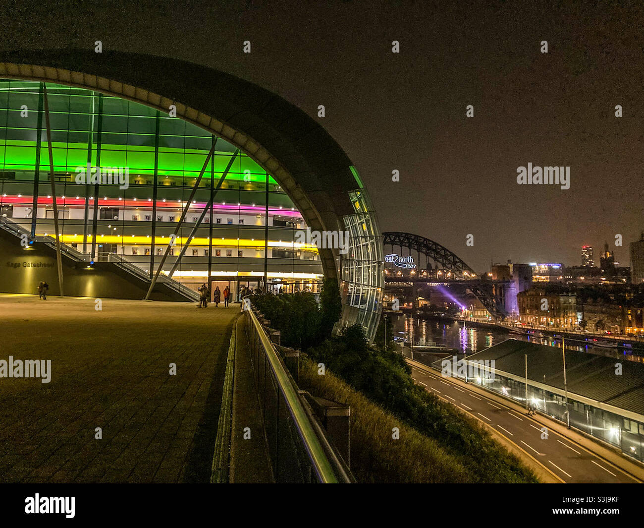 The Sage at Gateshead with the Tyne Bridge to Newcastle in the background, all lit up at night - Smartphone Captured Stock Image