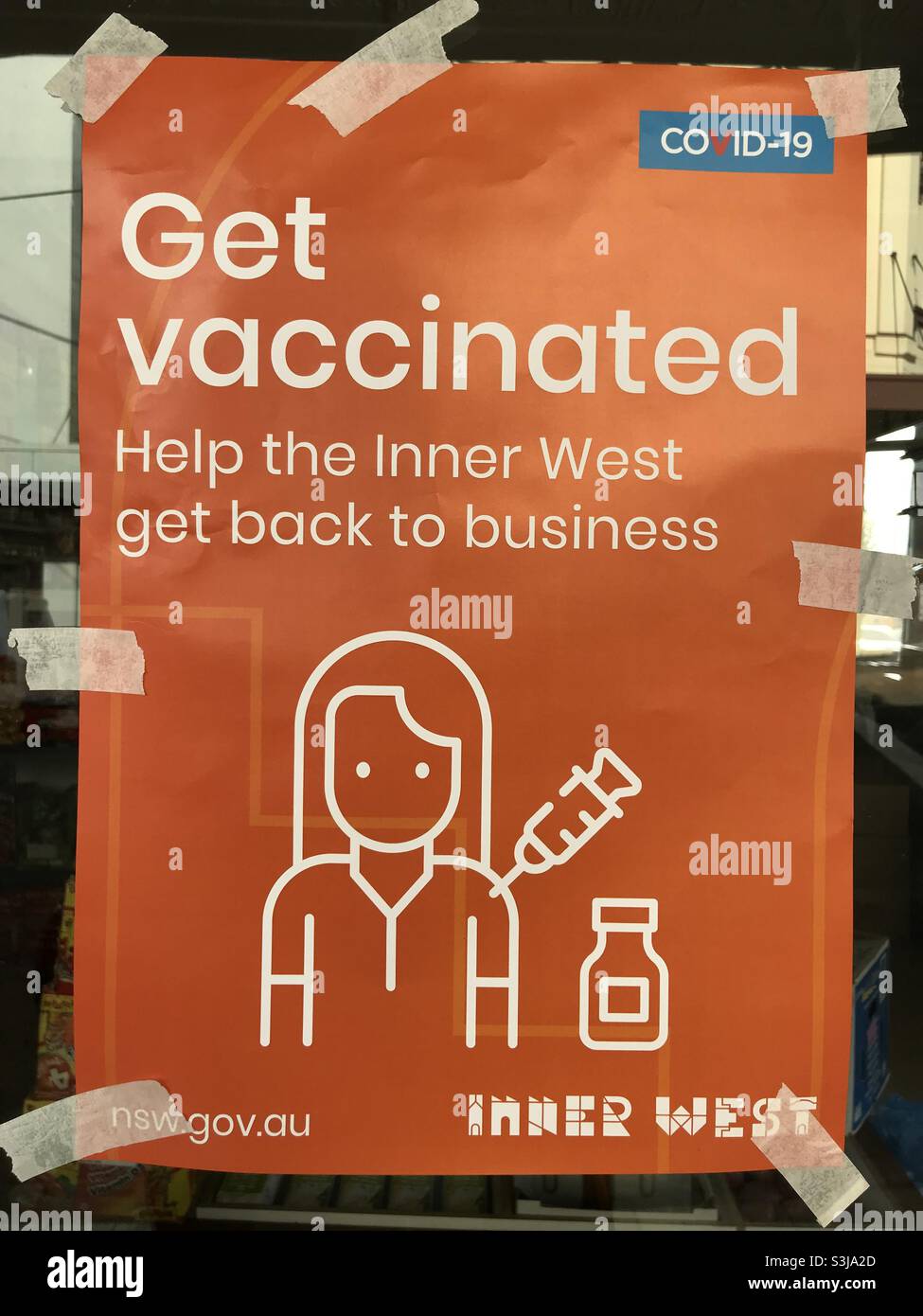 ‘Get vaccinated. Help the Inner West get back to business’ sign in a window of a shop in Ashfield. Stock Photo