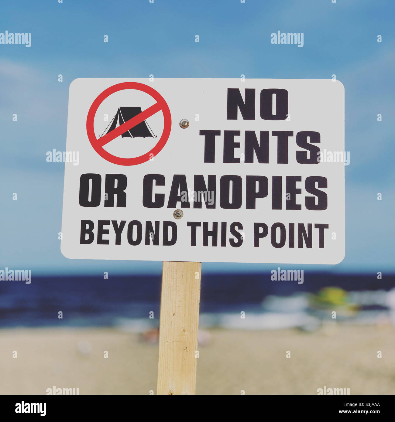 Sign on a beach reads “No Tents or Canopies Beyond This Point,” United States, North America - Smartphone Captured Stock Image