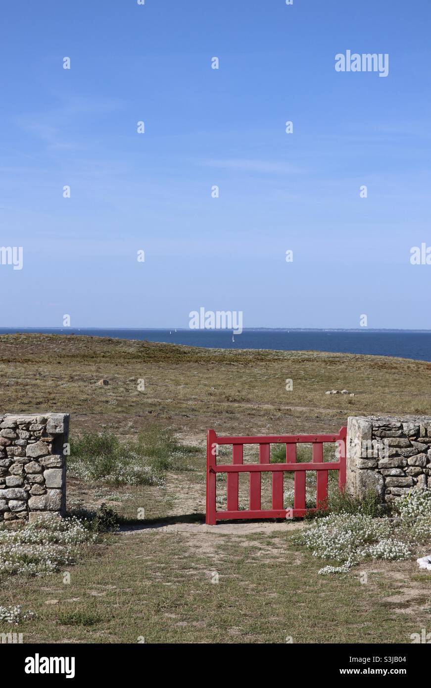 Red fence at the island of Hoedic in Brittany, France - Smartphone Captured Stock Image