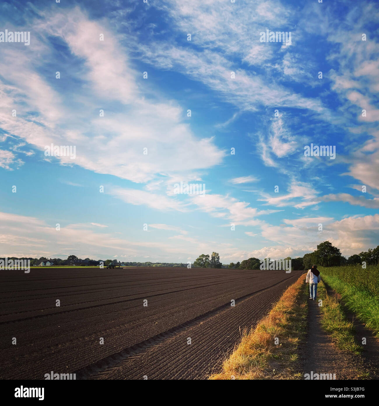 Walking at the edge of a ploughed field in Cheshire - Smartphone Captured Stock Image