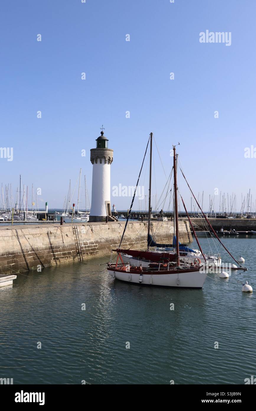 Boats and lighthouse of Port Haliguen in Quiber, Brittany, France - Smartphone Captured Stock Image