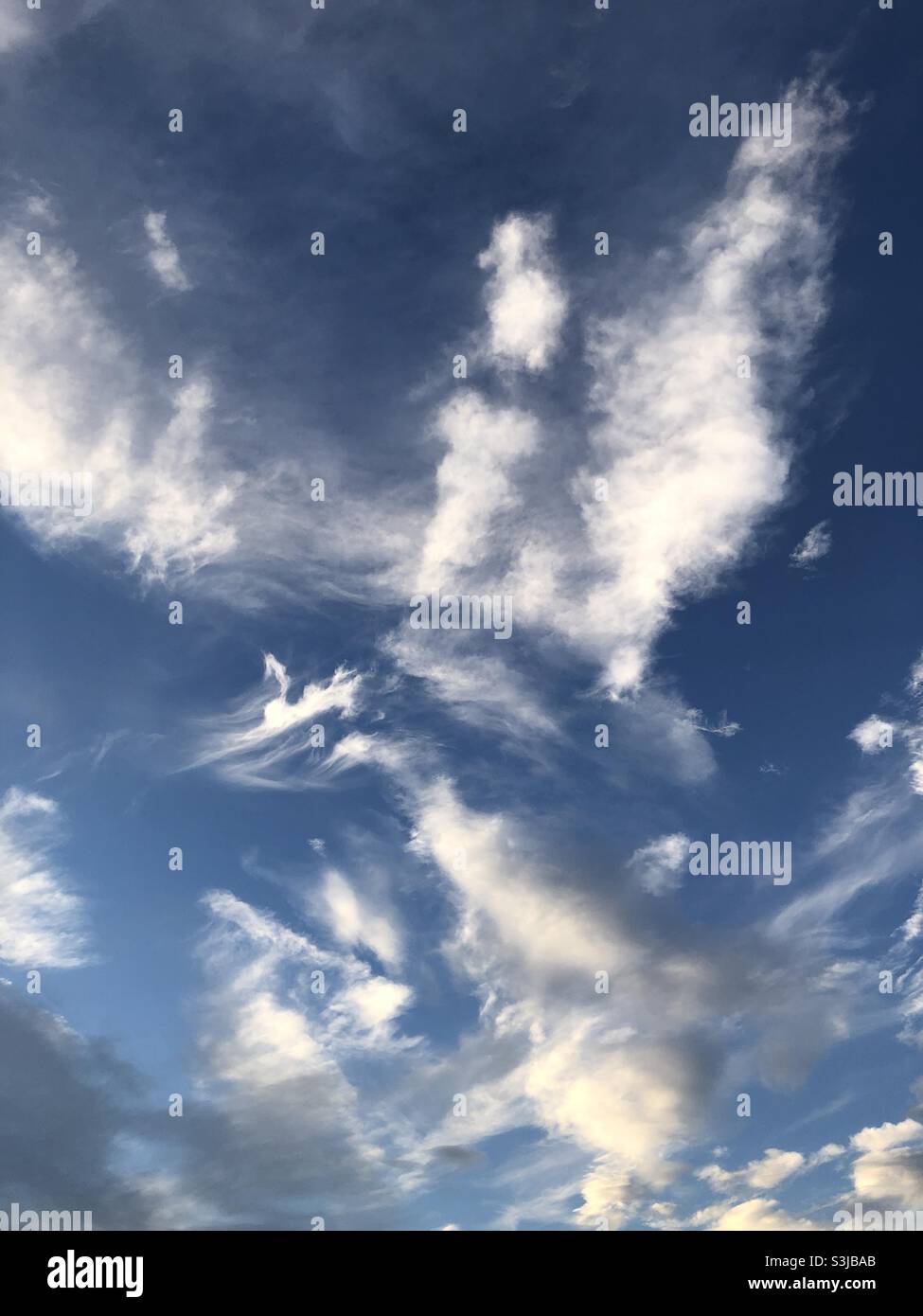 Blue sky with light clouds in a September evening in England, United Kingdom Stock Photo