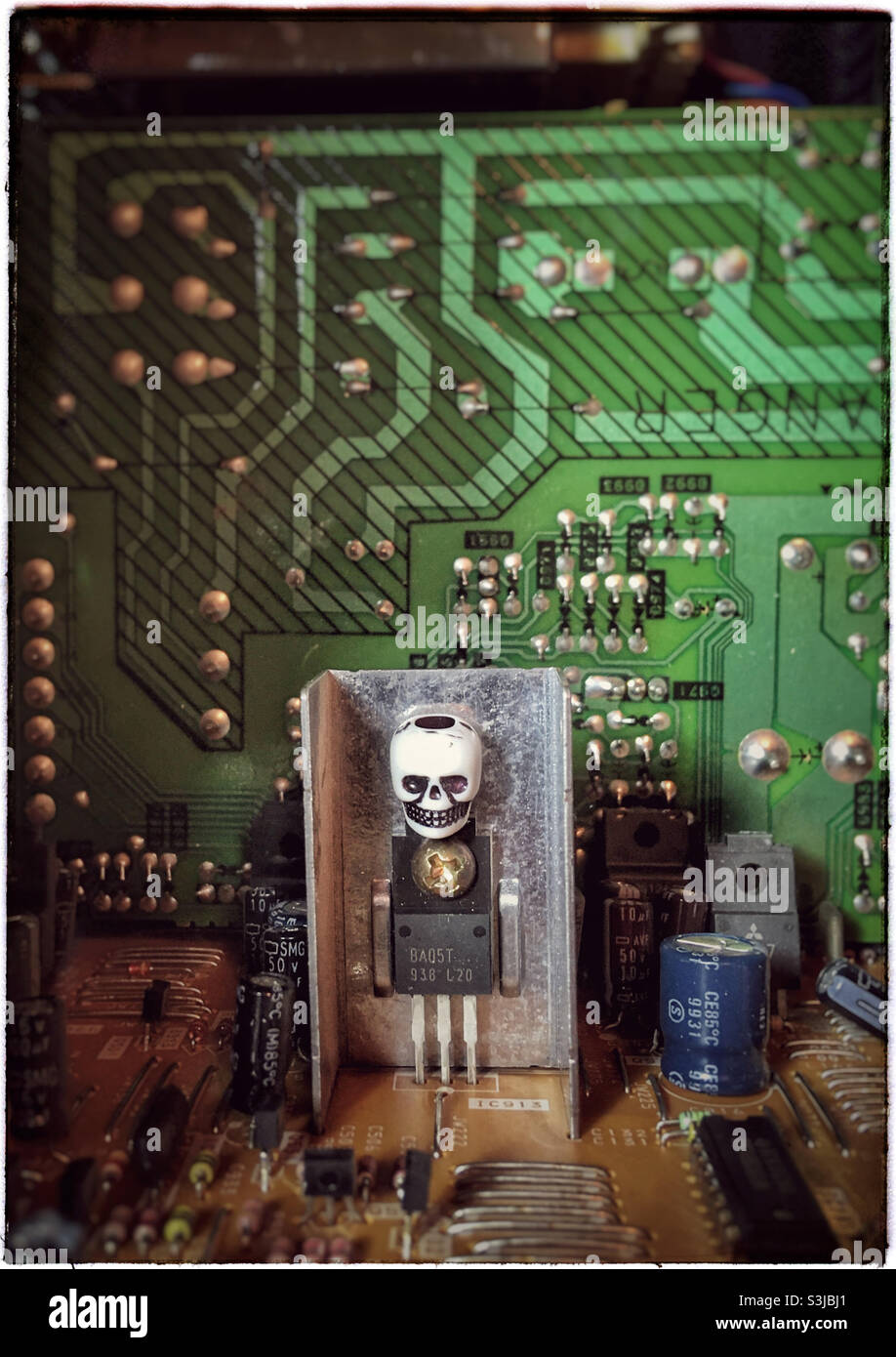 Steampunk style robot with skull on a circuit board - Smartphone Captured Stock Image