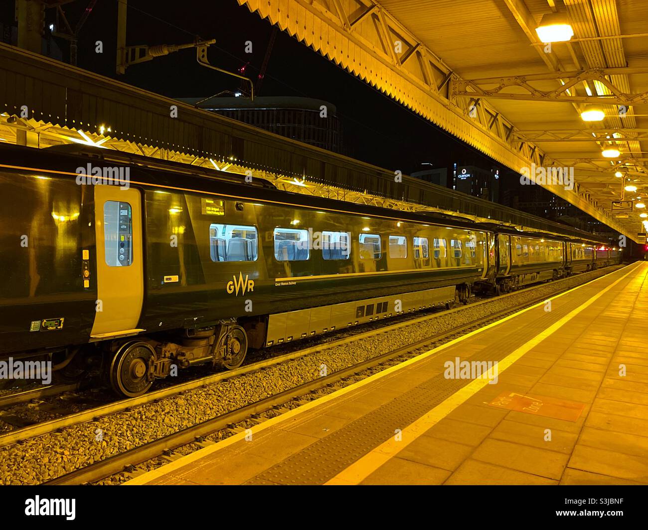 High speed train stopped in a railway station at night - Smartphone Captured Stock Image
