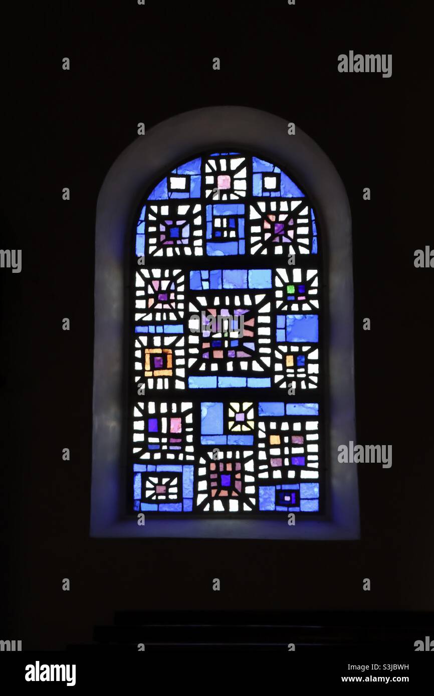 Stained glass windows in the church at the island of Hoedic in Brittany, France - Smartphone Captured Stock Image