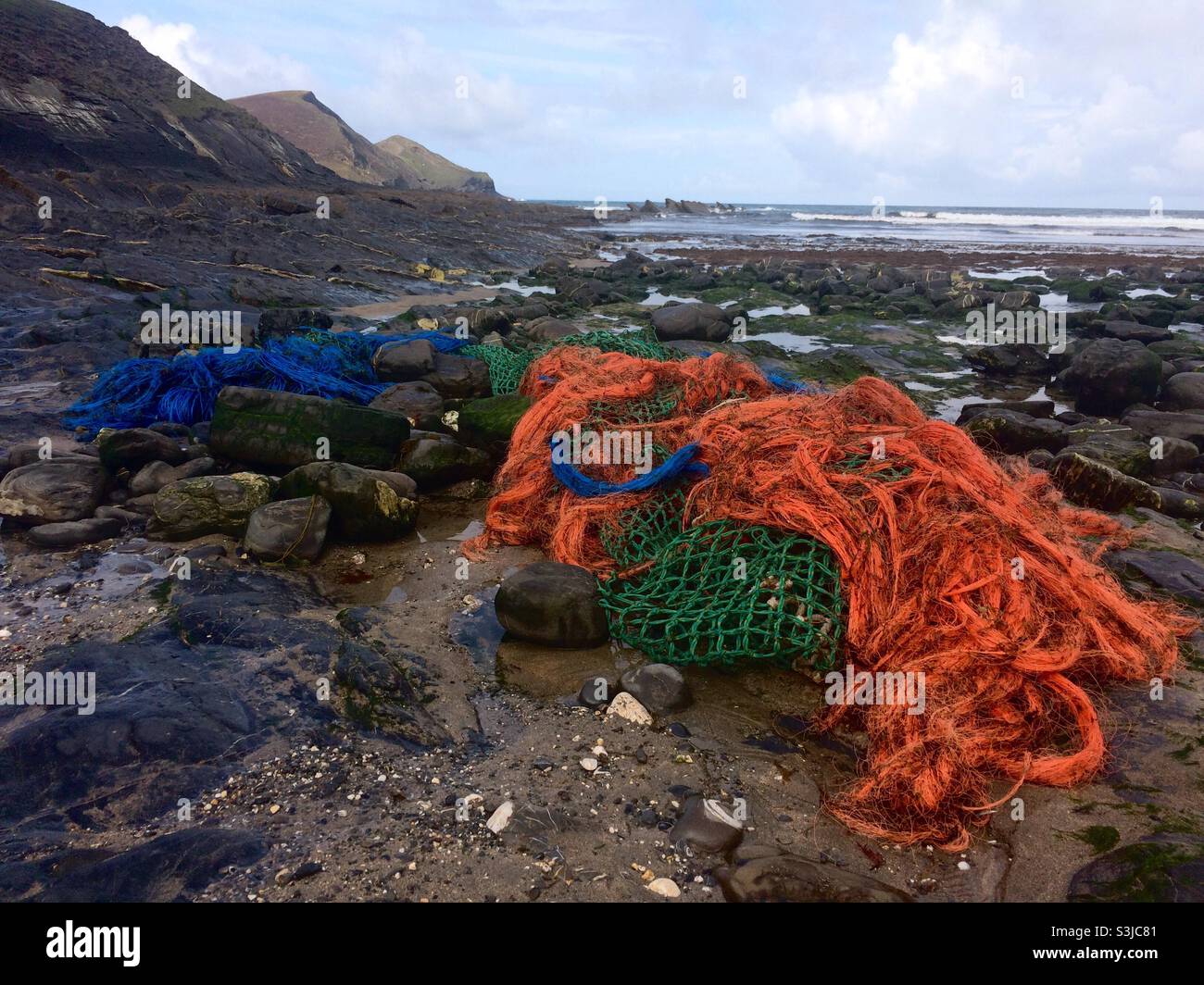 Washed up fishing gear on the shore including ropes and fishing