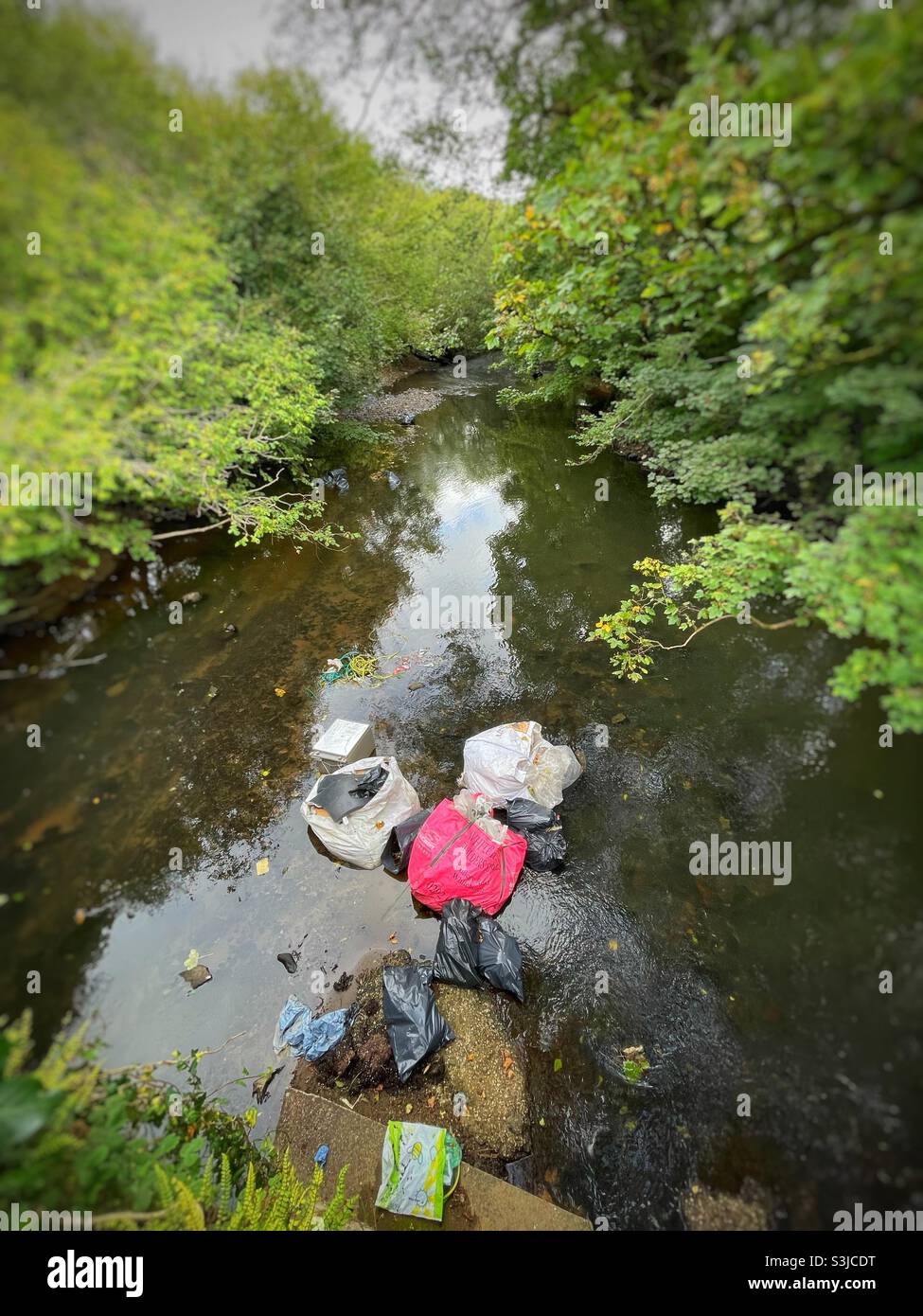 Fly tipping in the River Ely, near Cardiff, South Wales, 2021. - Smartphone Captured Stock Image