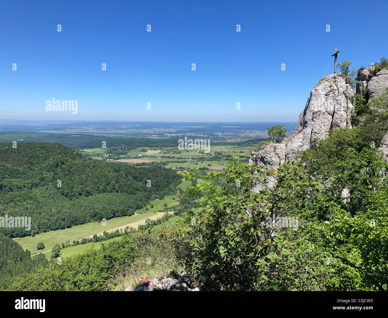 Scenic cliff ledge overlooking green valley in the Swabian Alps in Southern Germany - Smartphone Captured Stock Image