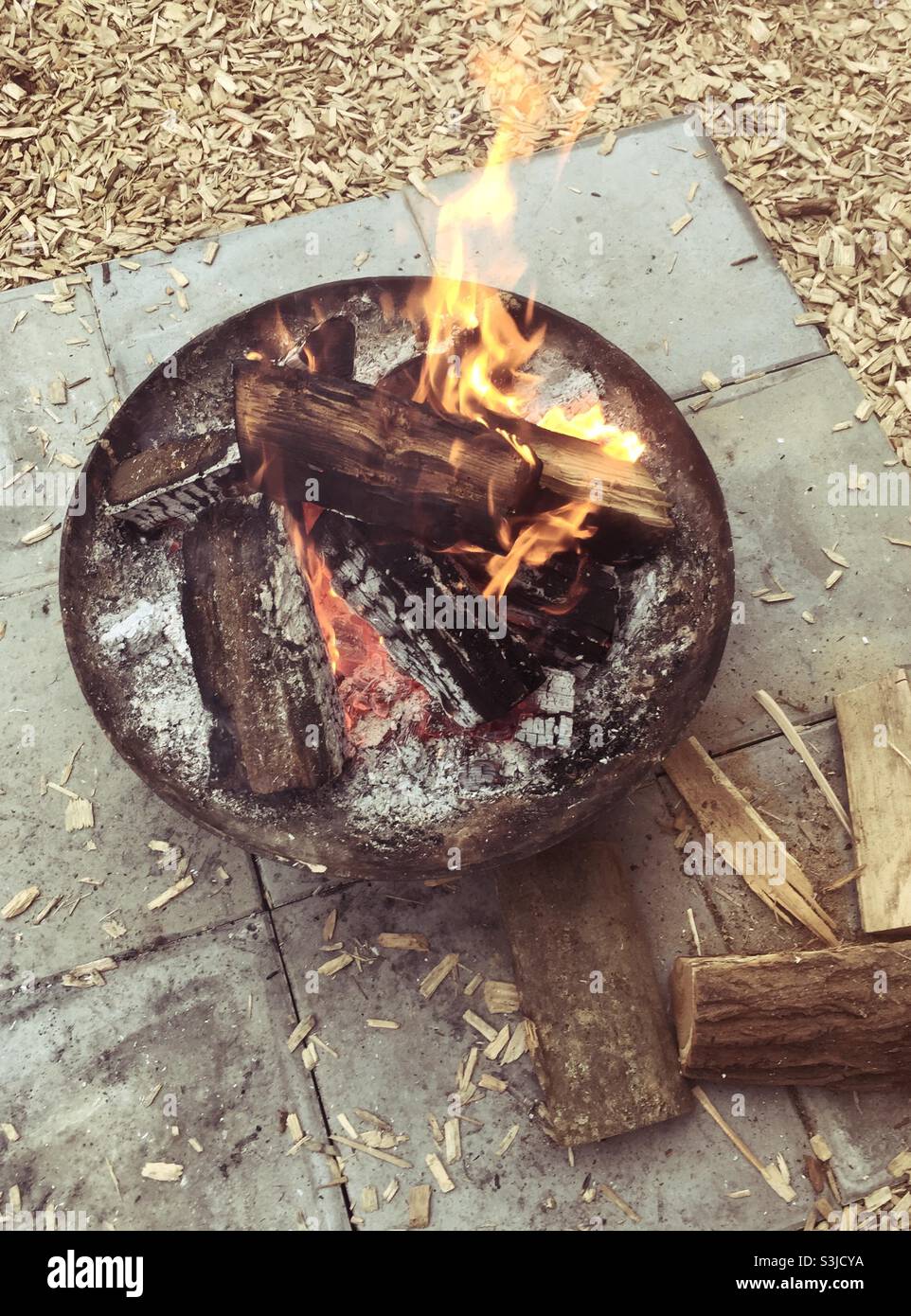 Outdoor fireplace in an iron bowl - Smartphone Captured Stock Image