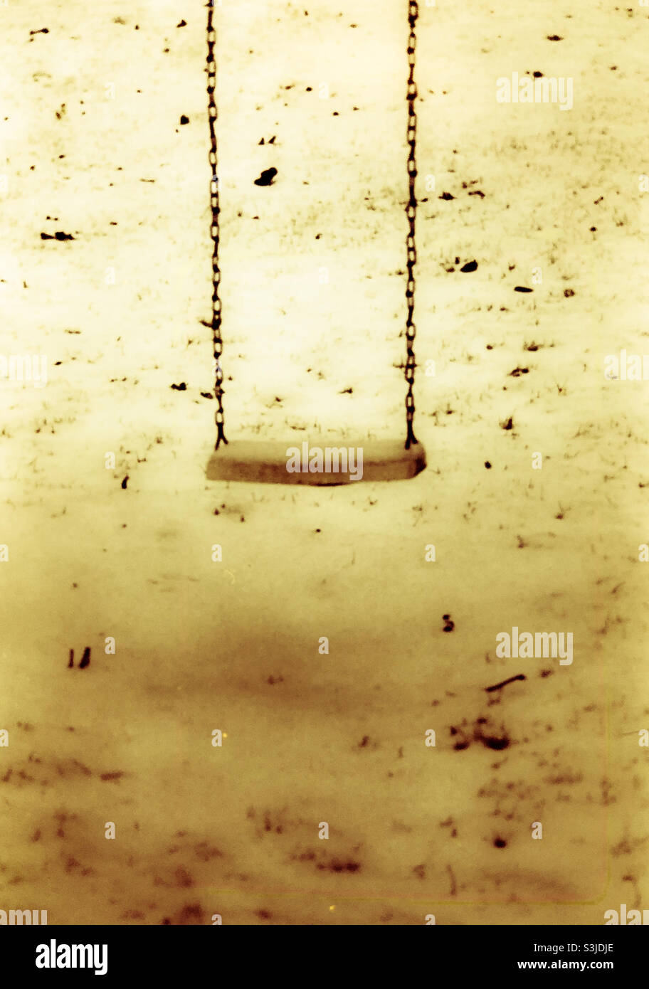 Playground swing in snow covered playground - Smartphone Captured Stock Image