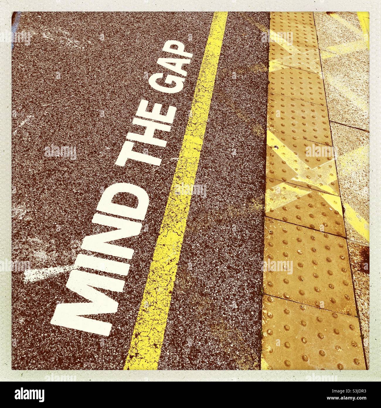 Mind the gap warning on a railway station platform, Northallerton, North Yorkshire, England, United Kingdom Stock Photo