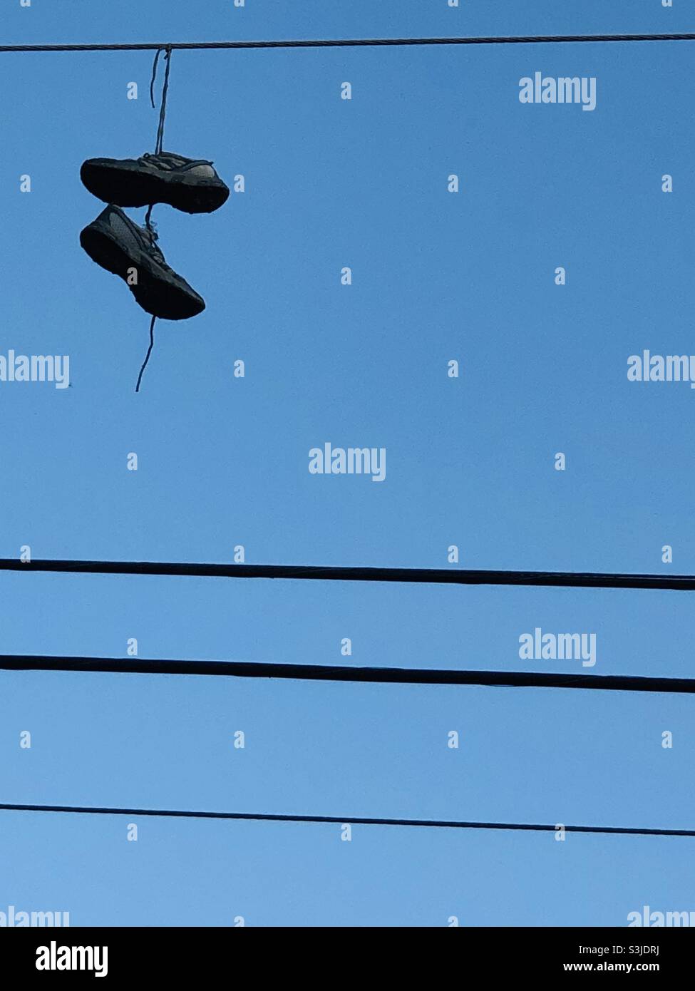 Tennis shoes hanging on electric wires Stock Photo Alamy