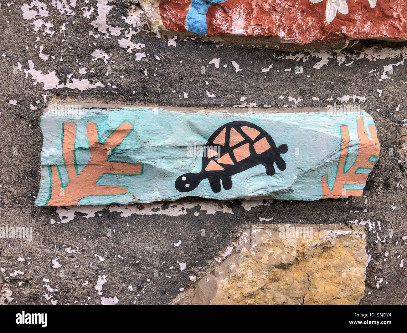 A turtle painted on a building exterior. - Smartphone Captured Stock Image