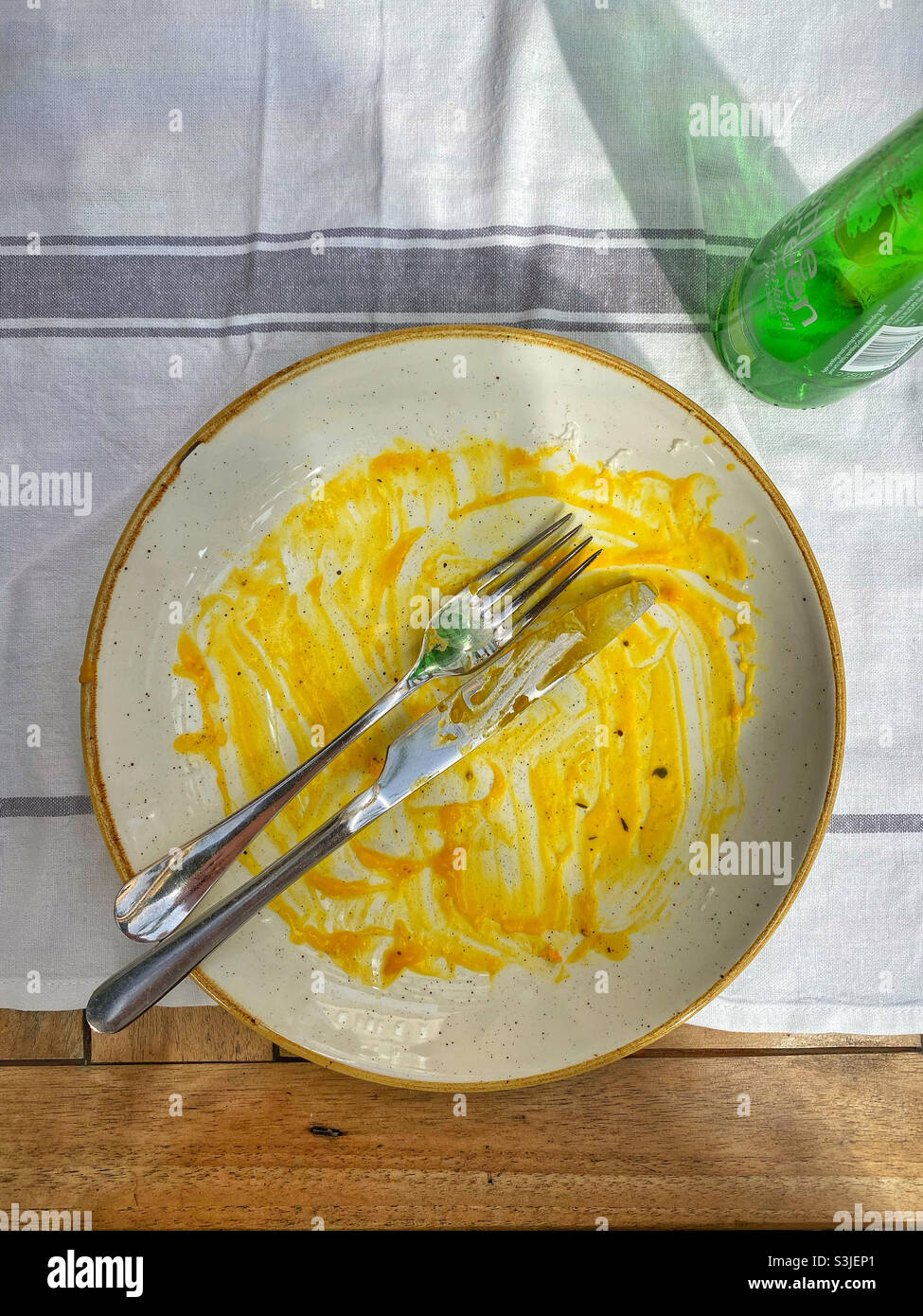 The end of a meal - all that’s left is a small amount of sauce! Must have been good and tasty food! Photo Credit ©️ COLIN HOSKINS. - Smartphone Captured Stock Image