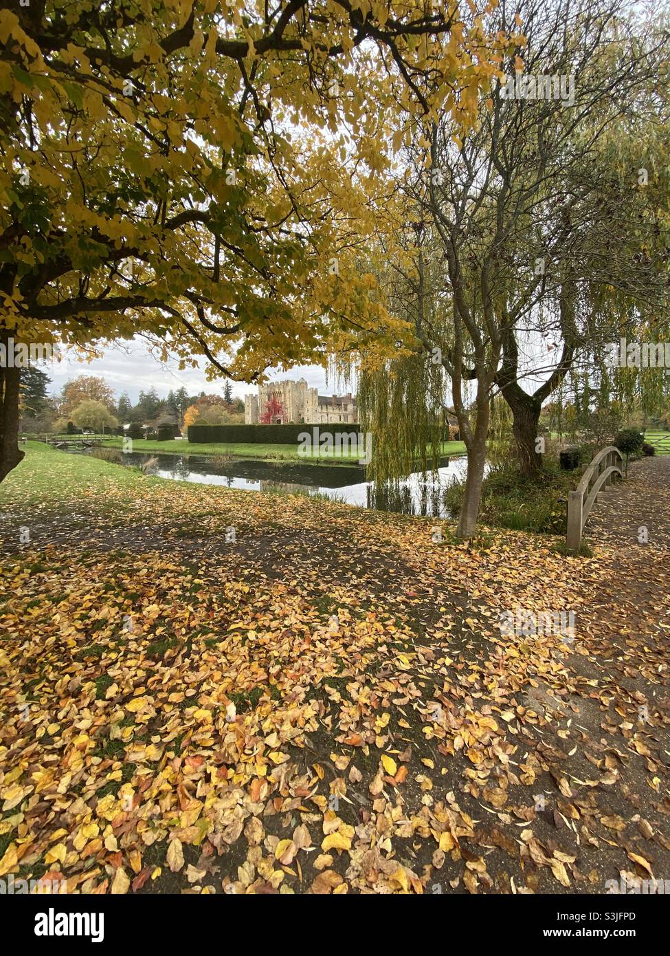 Hever Castle, Kent, U.K. photo taken in November 2019 through trees with autumnal colours. Stock Photo