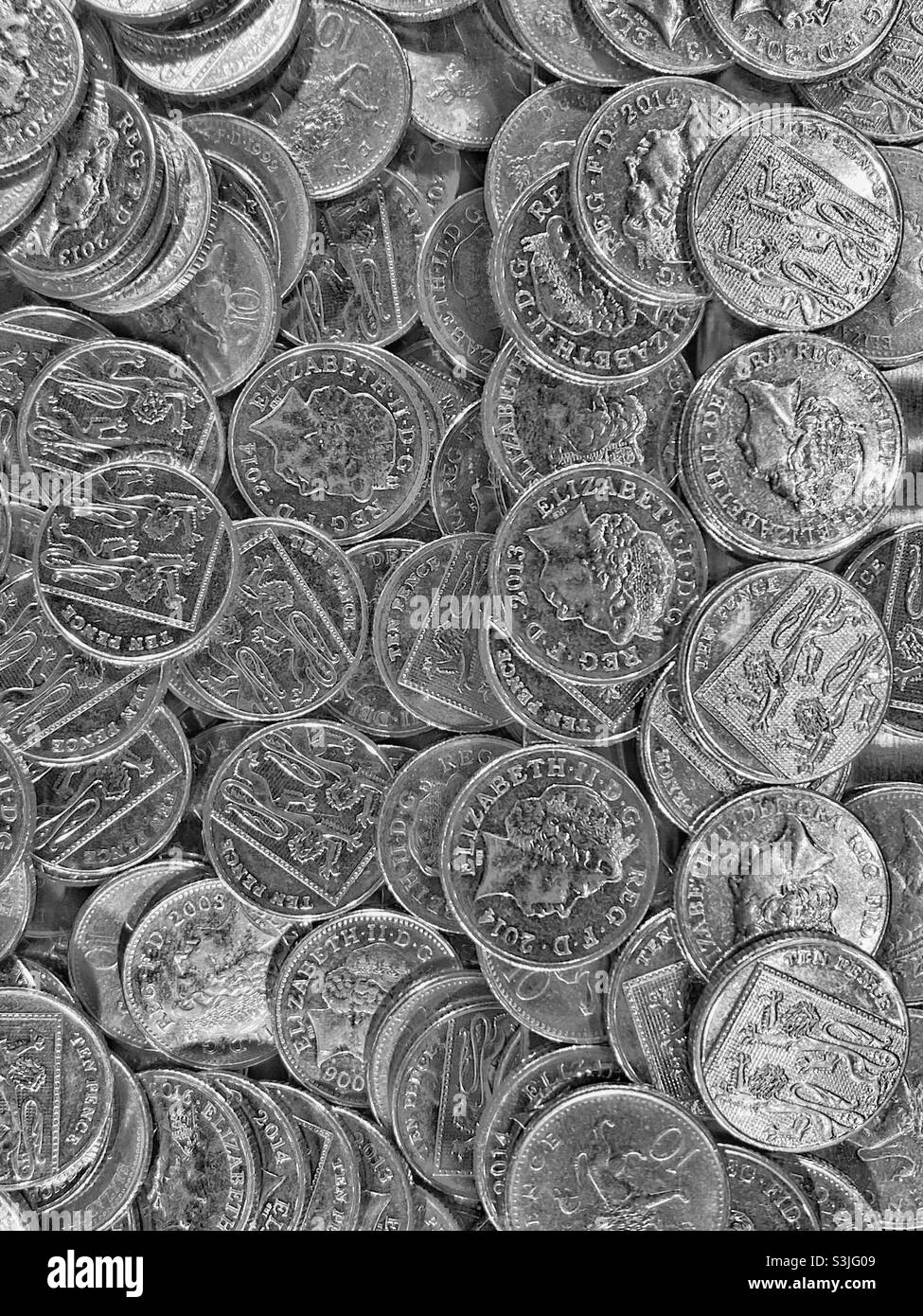 A collection of British 10 pence silver coins. A sight common in banks, casinos & amusement arcades. Queen Elizabeth II portrait features on one side. Photo Credit - ©️ COLIN HOSKINS. - Smartphone Captured Stock Image