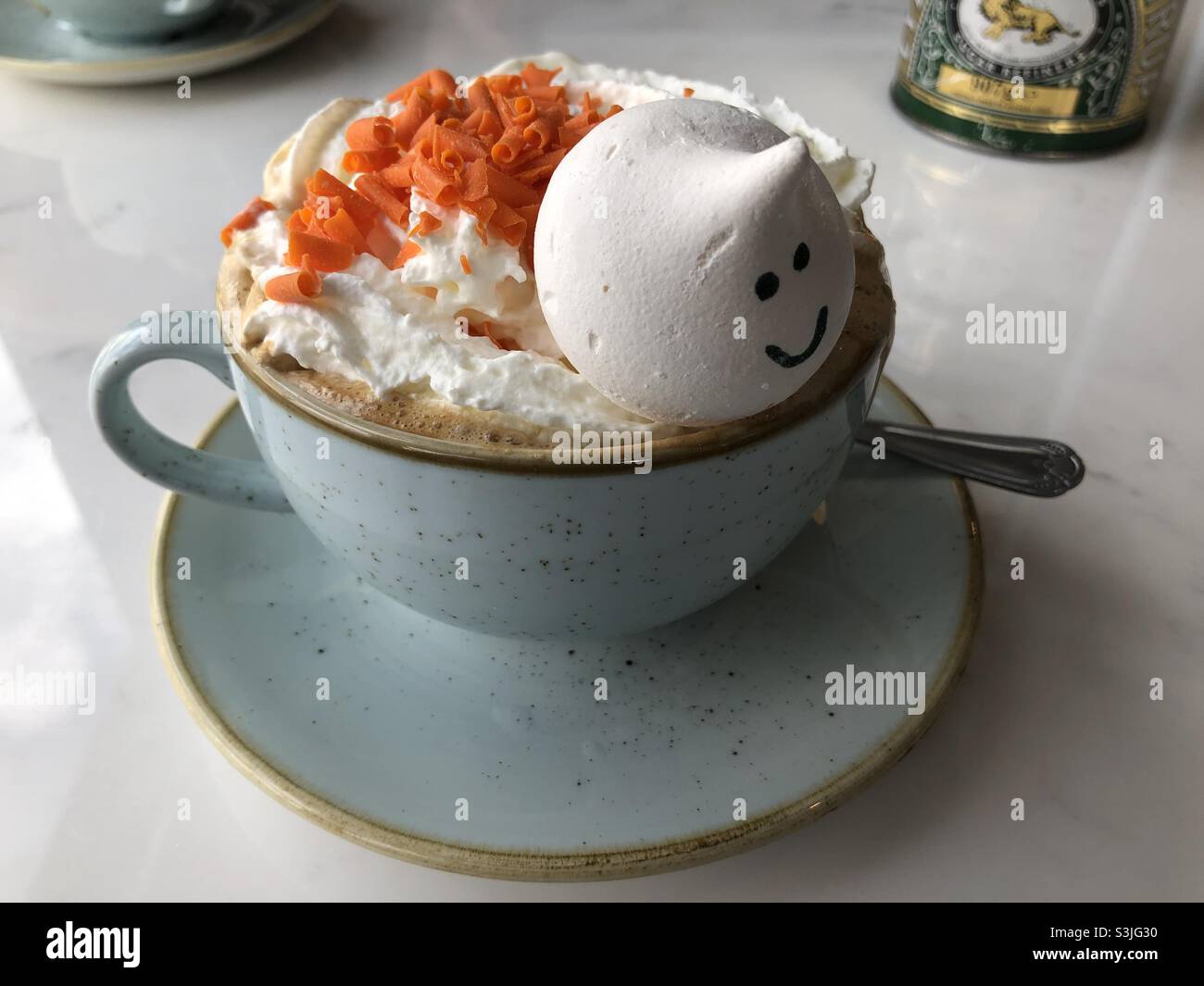 Pumpkin spice latte coffee with a “ghost” meringue in a cup and saucer Stock Photo