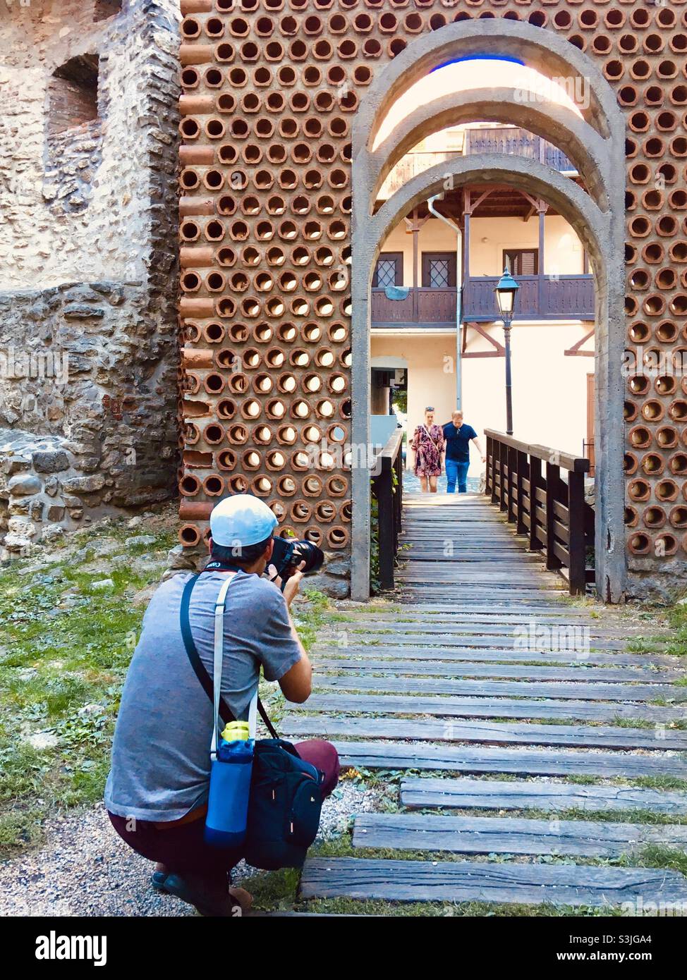 Photographer caught in action at gate through town wall, Sopron, Hungary - Smartphone Captured Stock Image