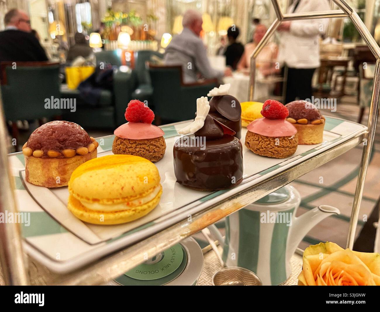 Afternoon Tea at Claridges in Mayfair, London. Plate of sweet treats, patisserie - Smartphone Captured Stock Image