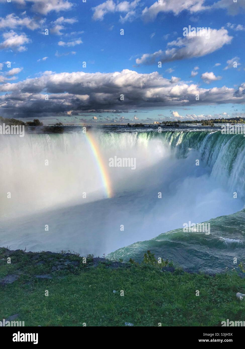 A rainbow forming in the Horseshoe Falls, Niagara, Canada. - Smartphone Captured Stock Image